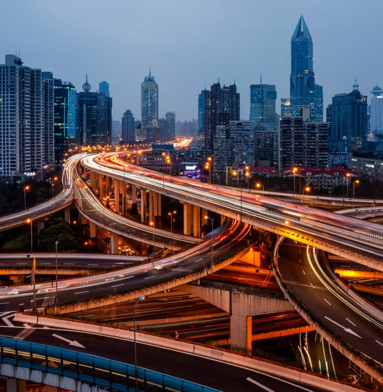 Slow exposure image of highway bridges against city skyline