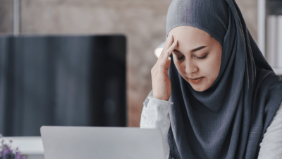 Woman looking at a laptop with distressed a face