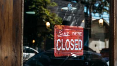 A door with a 'sorry we're closed' sign on it.