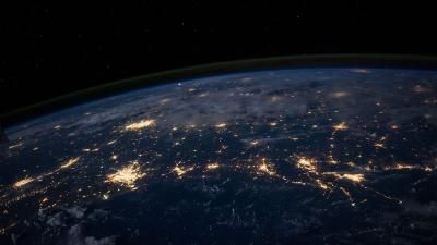 A photograph from space of the Earth. You can see lights representing densely-populated areas.