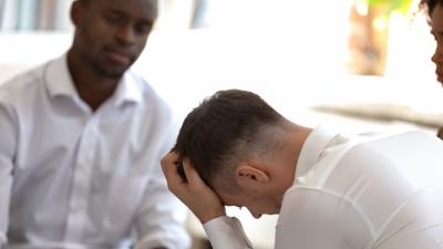 Man looking down seemingly distressed