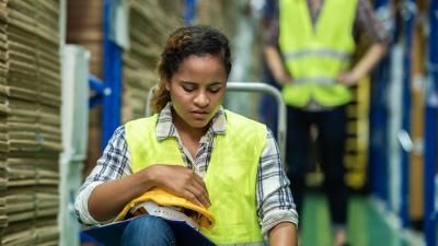 Woman wearing hi-vis vest looking concerned