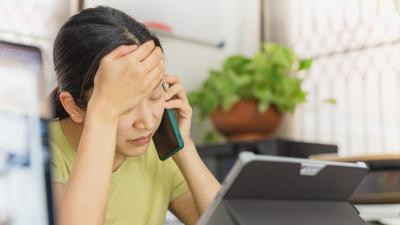 woman on the phone looking distressed