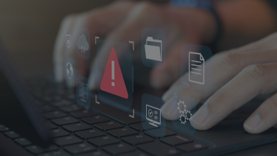 A generic image of someone on a laptop, holographic icons and a warning symbol can be seen.
