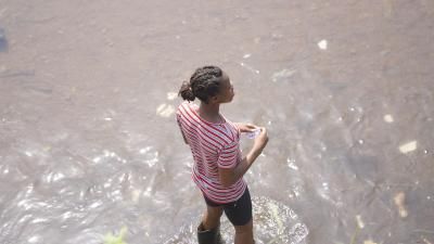 Woman wearing boots standing in flooded area