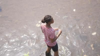 Woman wearing boots standing in flooded area