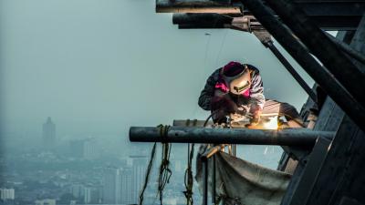 man welding in an unsafe environment