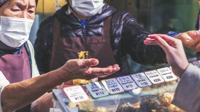 Masked workers selling goods