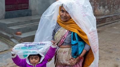 Woman and child walking in the rain