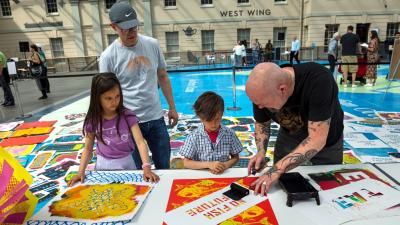 Two children taking part in an activity at the National Maritime Museum, Greenwich.