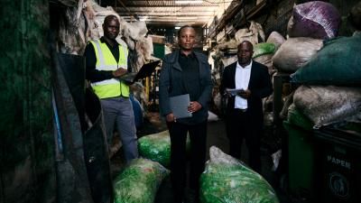 A photograph taken at Boredo Supplies Ltd in Nairobi County shows three individuals standing side by side.