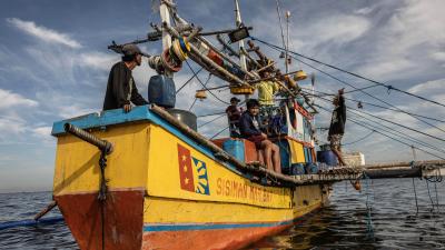 Local fisherman sit on boat in the Philippines
