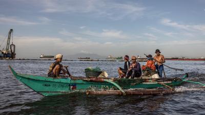 Filipino fisherman on board small fishing boat 
