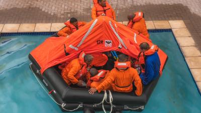 People carrying out a safety training on a life raft