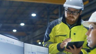 Workers at a monitor working