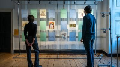 Two people can be seen viewing the exhibition, held at Somerset House, London.