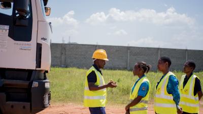 workers in high-vis jackers engage in conversation