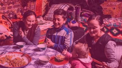 Mongolian family sitting around dinner table