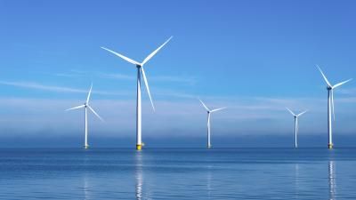 wind mill turbines in the ocean aerial view