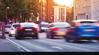 Cards driving down a road