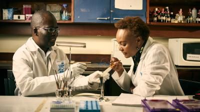 male and female use science equipment in university setting