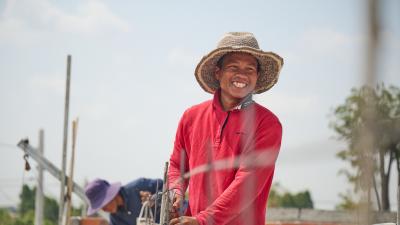 construction worker in Cambodia smiles at camera