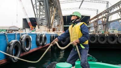Port worker on tugboat