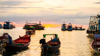 Colourful sky with boats in sea