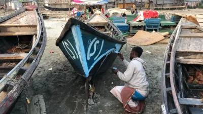 Man painting small boat