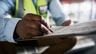 Man writing on checklist