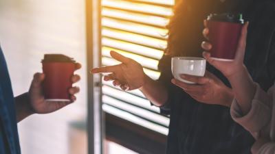 People enjoyed talking and drinking coffee together in office