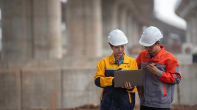 Two colleagues discussing construction plans