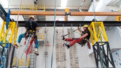 Two workers doing climbing training.