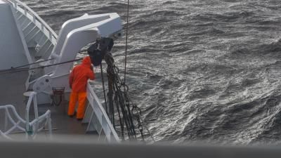 fishermen at work in rough sea