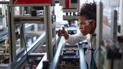 Engineer working with precision equipment in a factor