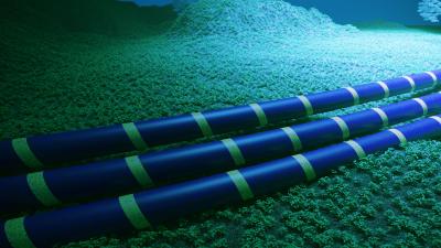 Underwater submarine cables lying on the seafloor with blue tubes wrapped in green bands.