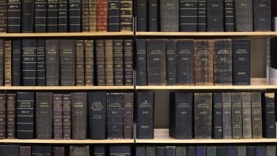 Shelves of Lloyd's Register books spanning various years from the 1890s to 1940s