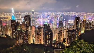 Night view of Hong Kong skyline from Victoria Peak, illuminated skyscrapers overlooking Victoria Harbor.