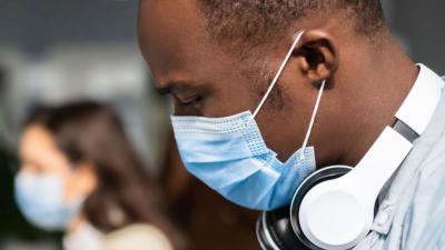 Man looking down wearing a facemask at work