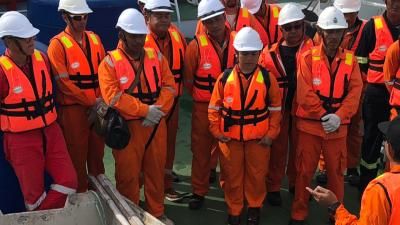 Maritime workers during a safety briefing