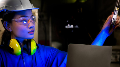 Engineer testing an Artificial Intelligent welding robotic automatic arm